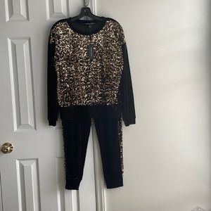 NWT.   Outfit with bling!  Sweatshirt and joggers ( sold as a set)